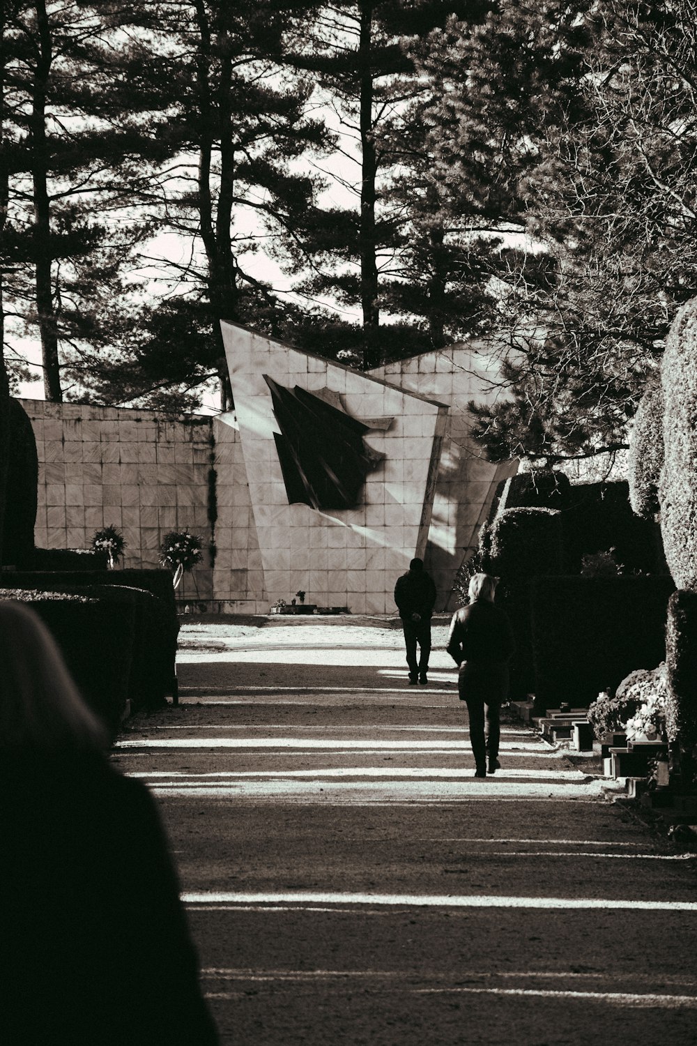 a black and white photo of a person walking down a street