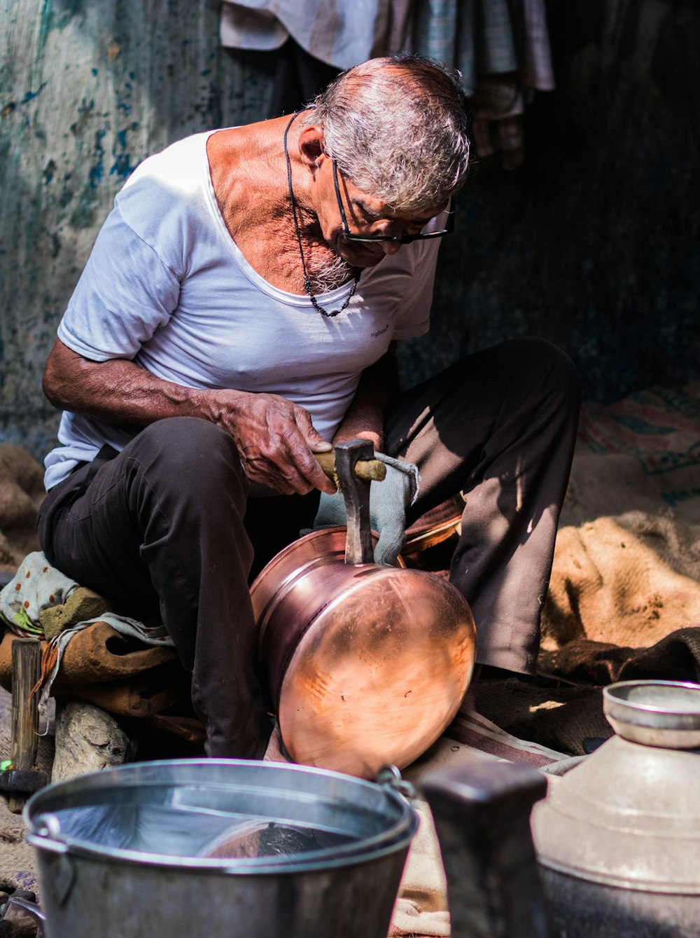 an old man is working on a pot