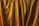 Golden curtains with folds and soft textures are prominently displayed, creating an impression of elegance and luxury.