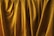 Golden curtains with folds and soft textures are prominently displayed, creating an impression of elegance and luxury.