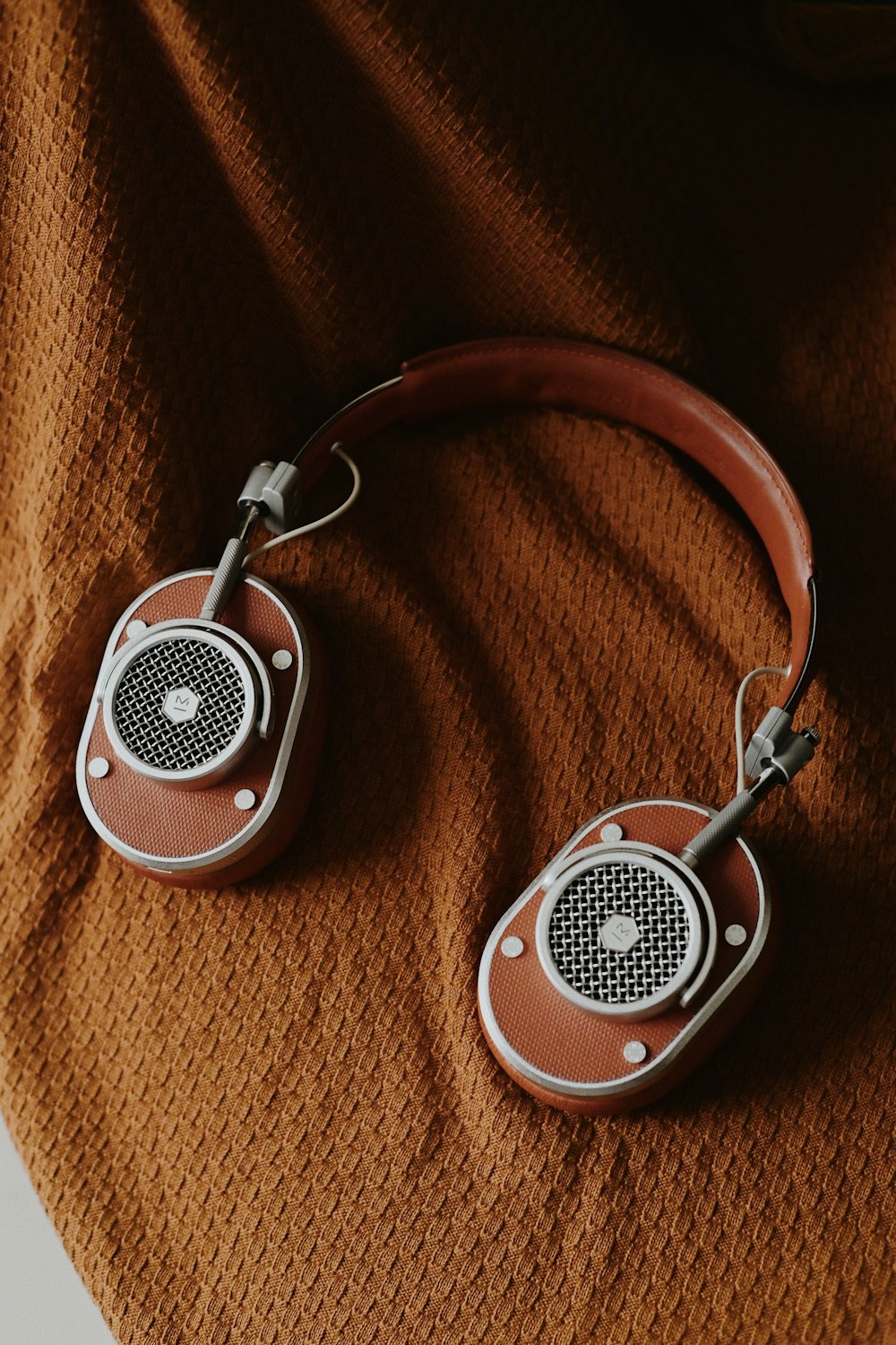 a pair of headphones sitting on top of a blanket