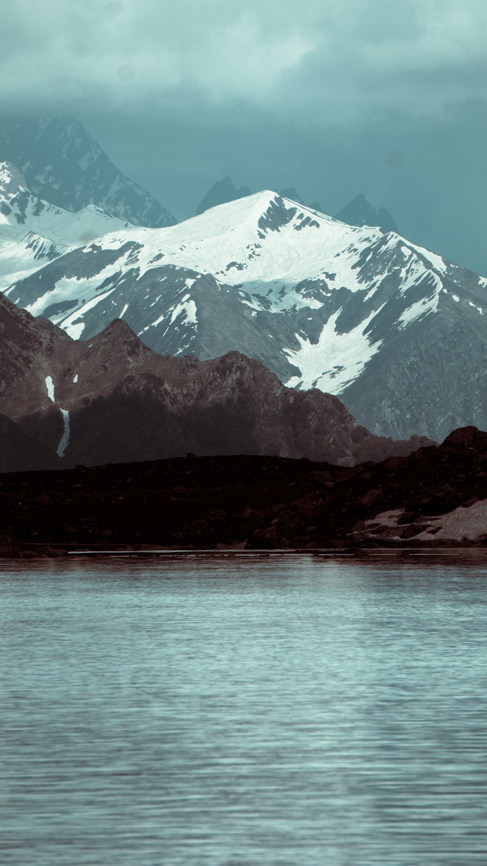 a mountain range with a body of water in front of it