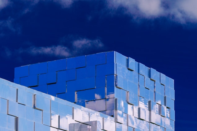 Modern architectural building with blue accents representing trust and professionalism.