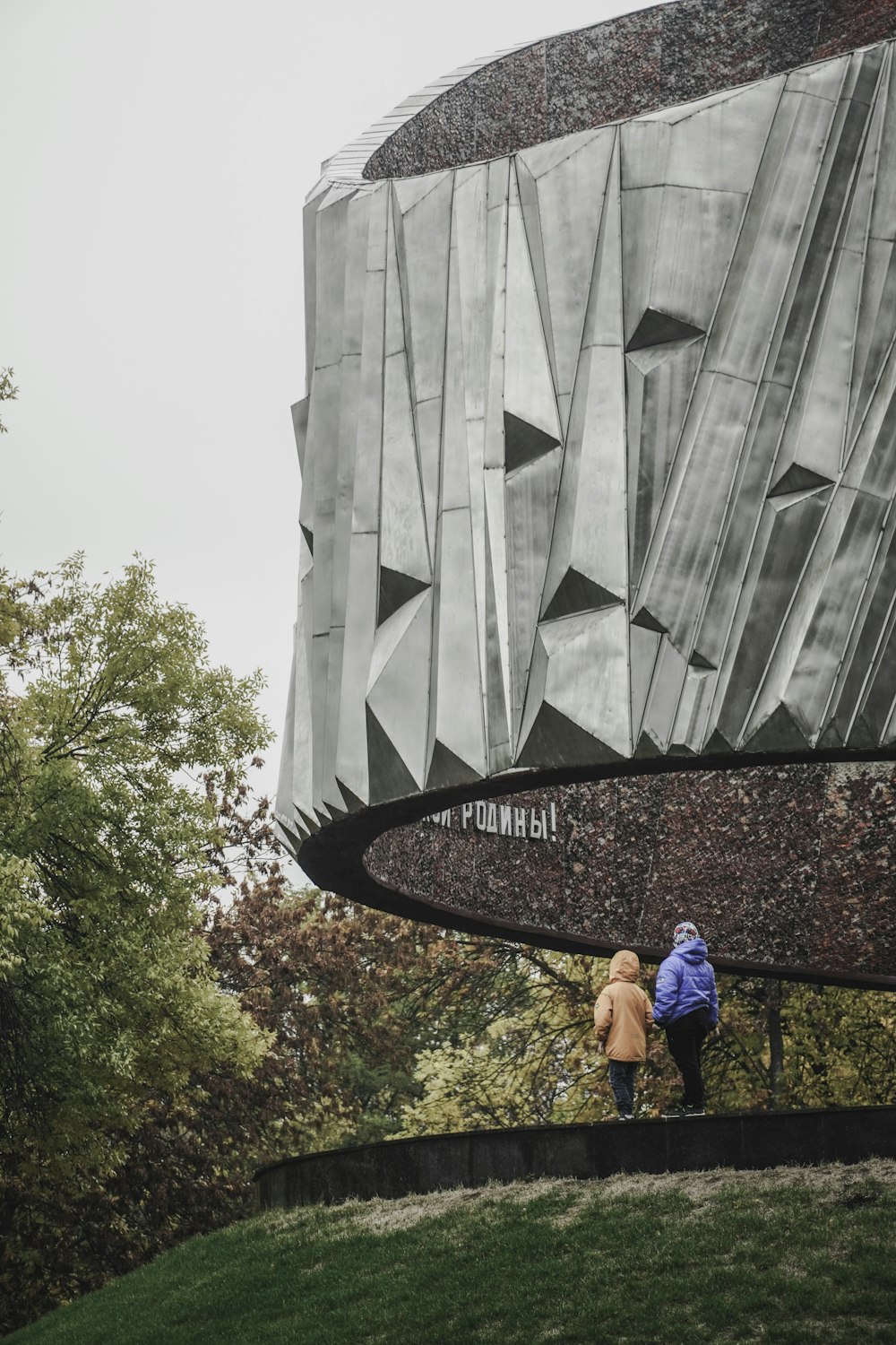 a couple of people that are standing in front of a building