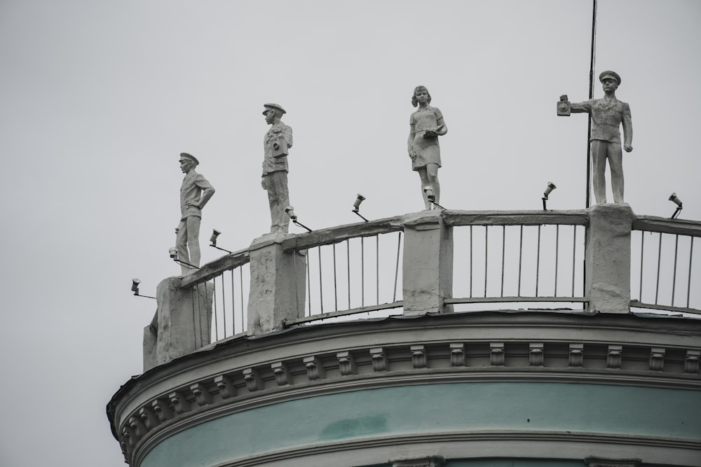 a group of statues on top of a building