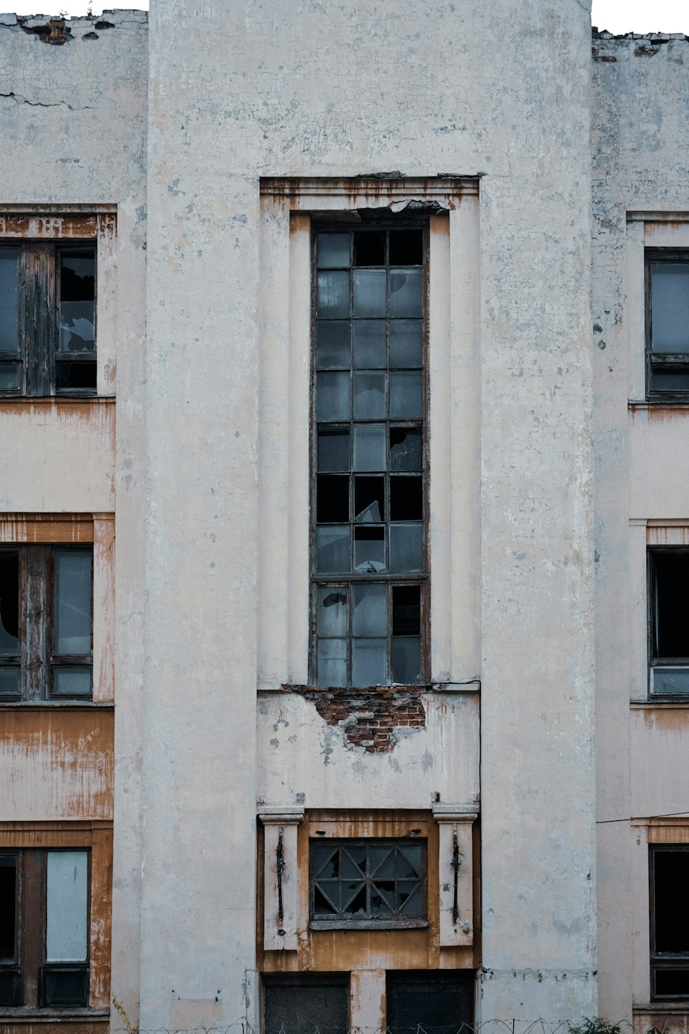 an old run down building with broken windows