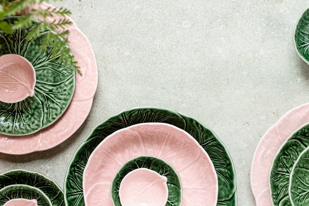 a group of green and pink plates sitting next to each other