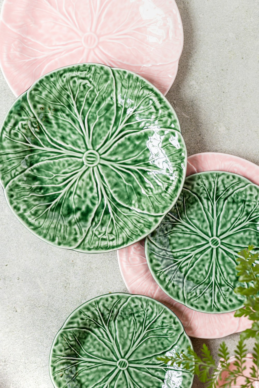 three green and pink plates sitting on top of a table