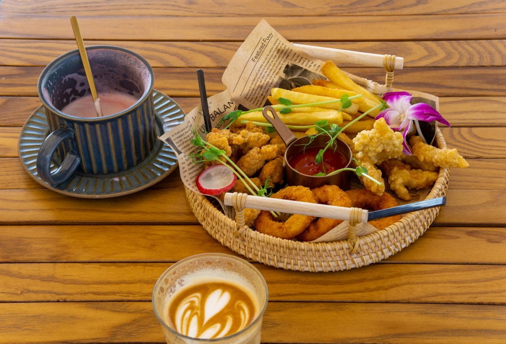 a basket of food next to a cup of coffee