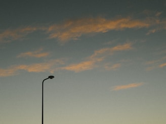 A minimalist video still showing a quiet street at dawn with soft pastel colors.