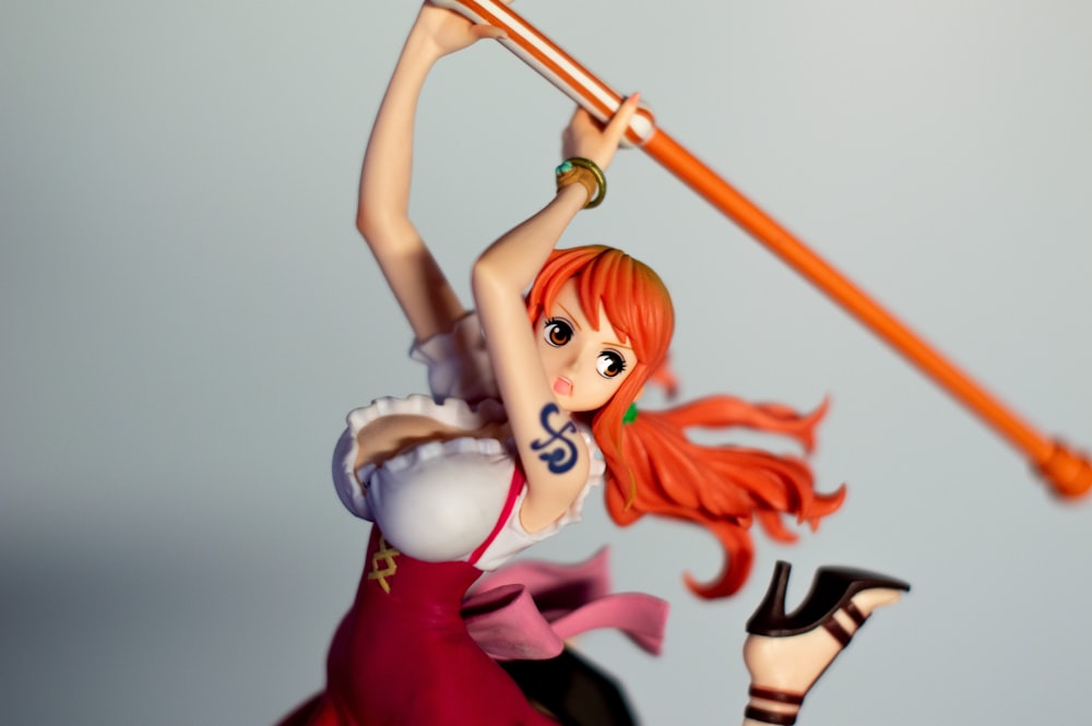 a figurine of a woman holding a baseball bat