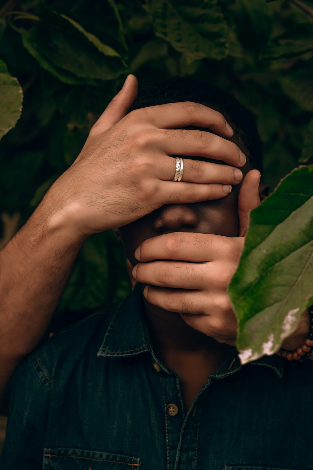 a close up of a person wearing a wedding ring