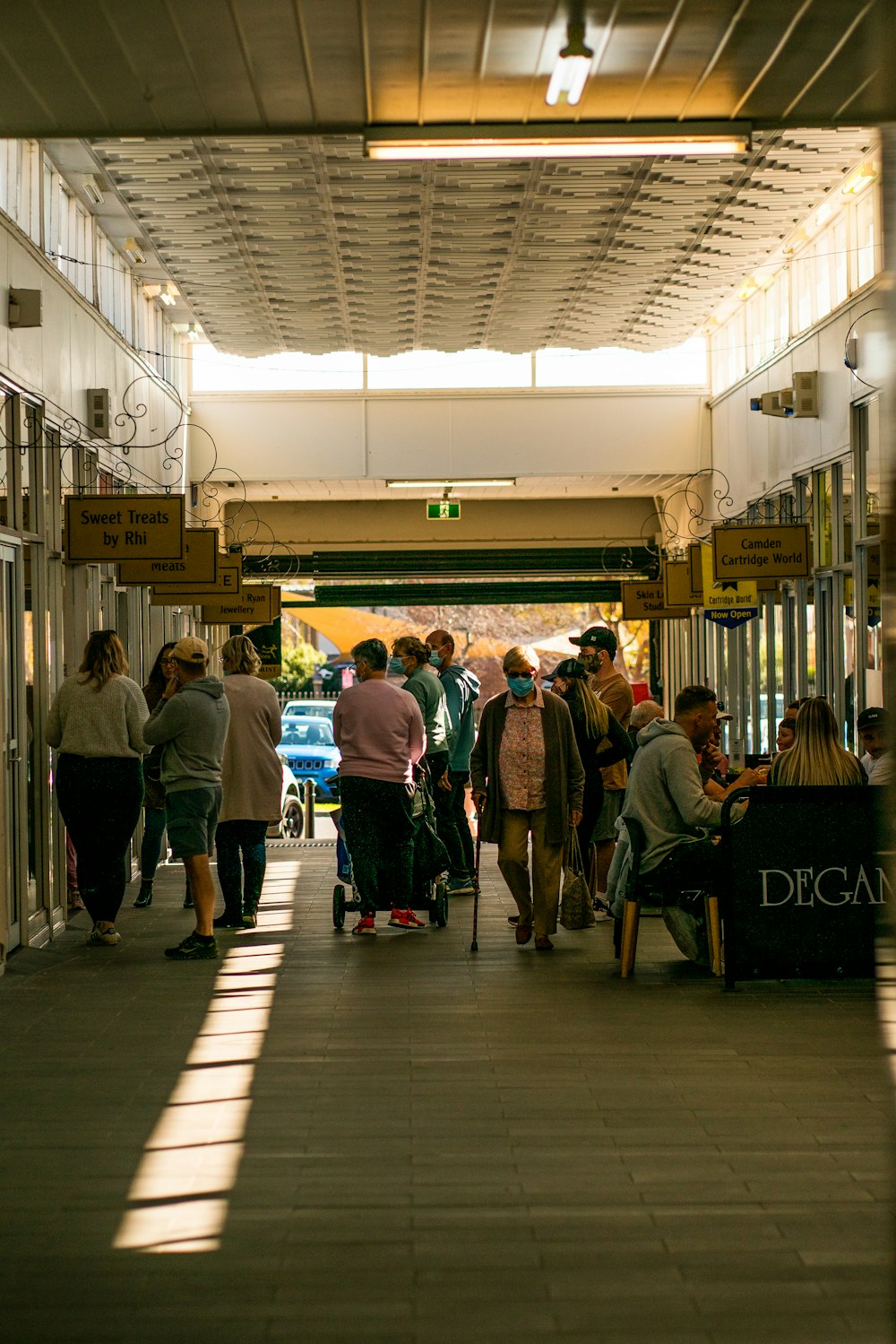 a group of people walking down a hallway