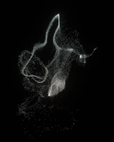Softly animated particles drifting over a dark matte background with faint cabalistic symbols.