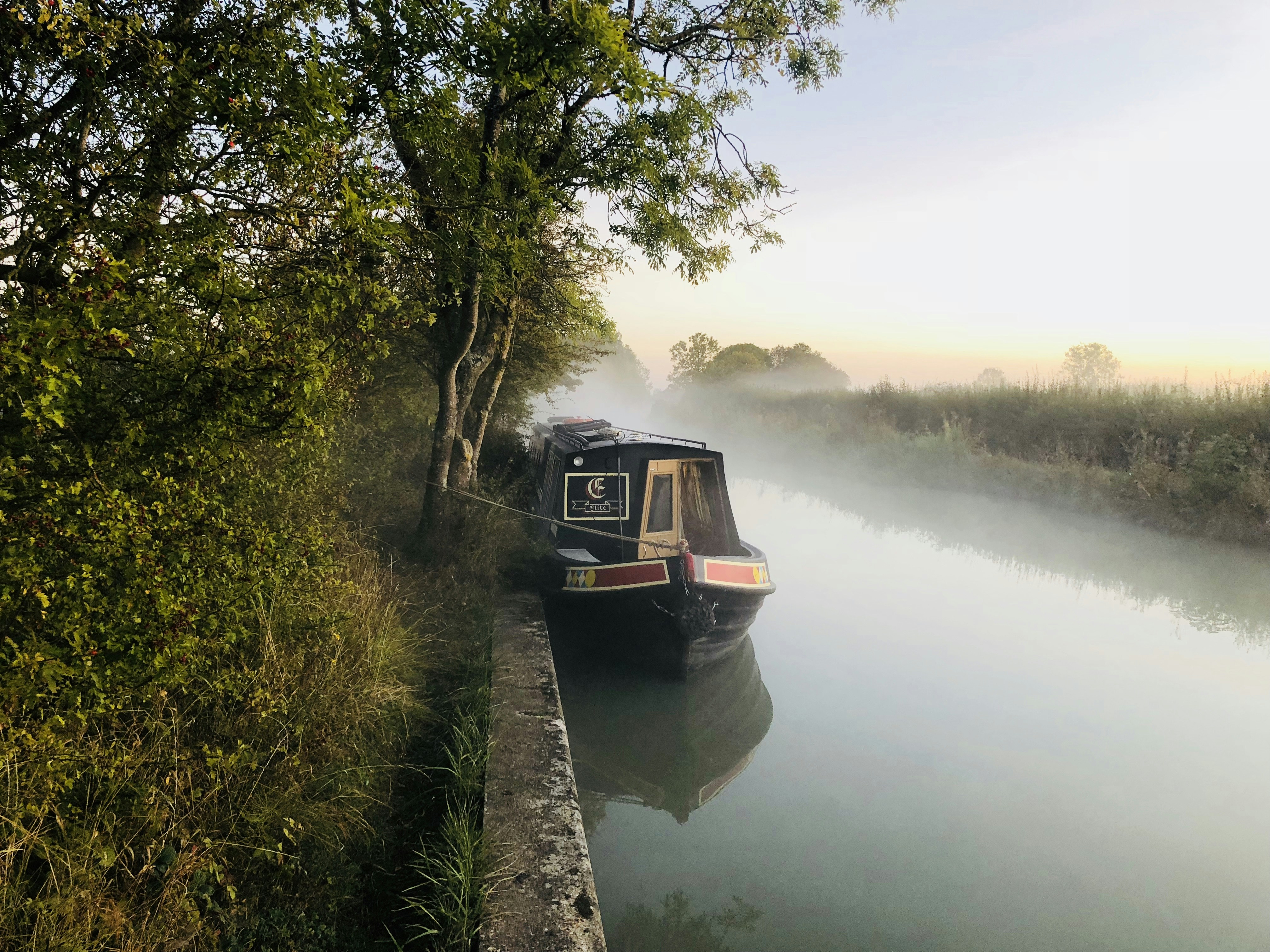 a train traveling down tracks next to a body of water, 