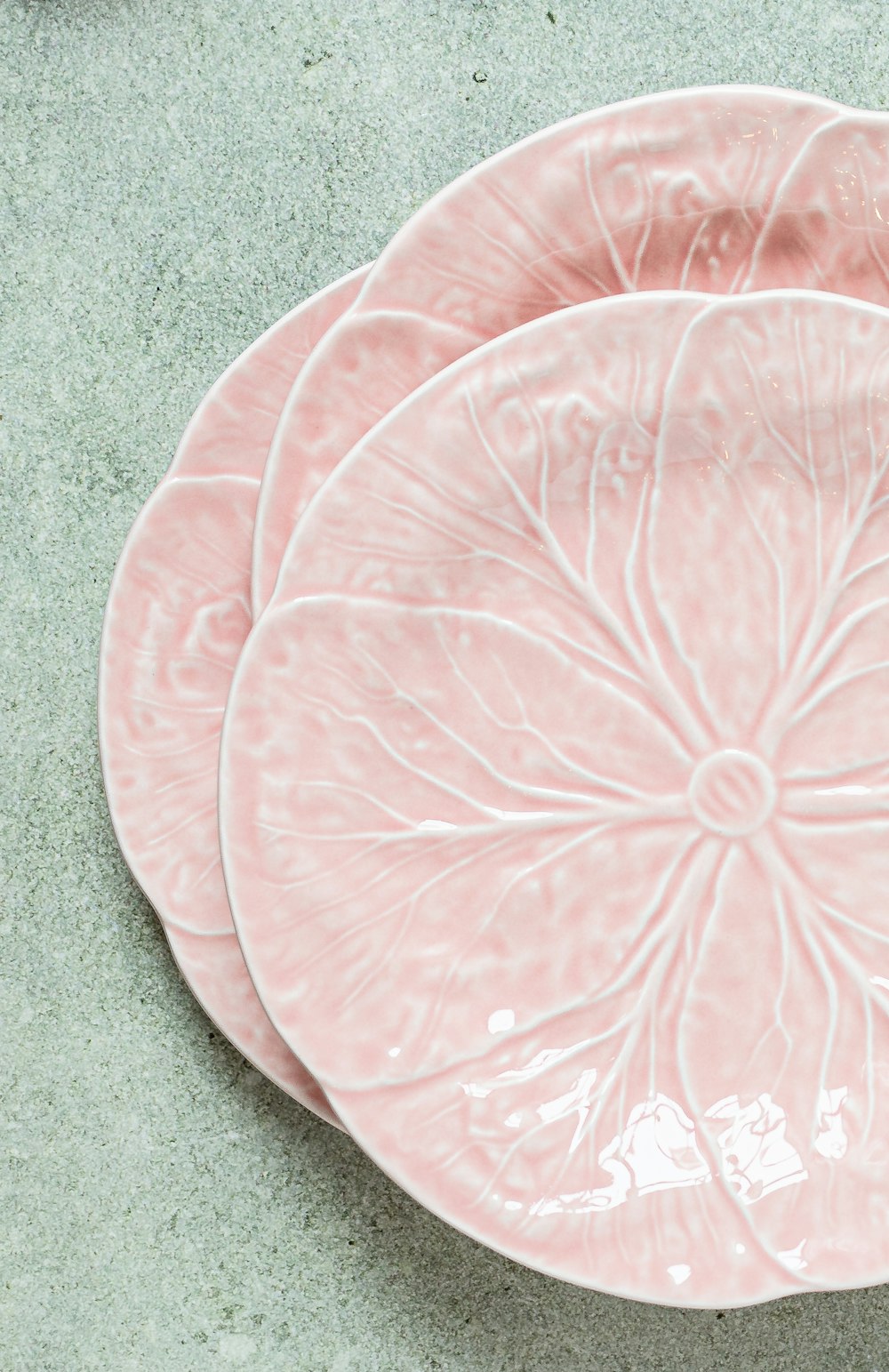 a couple of pink plates sitting on top of a table