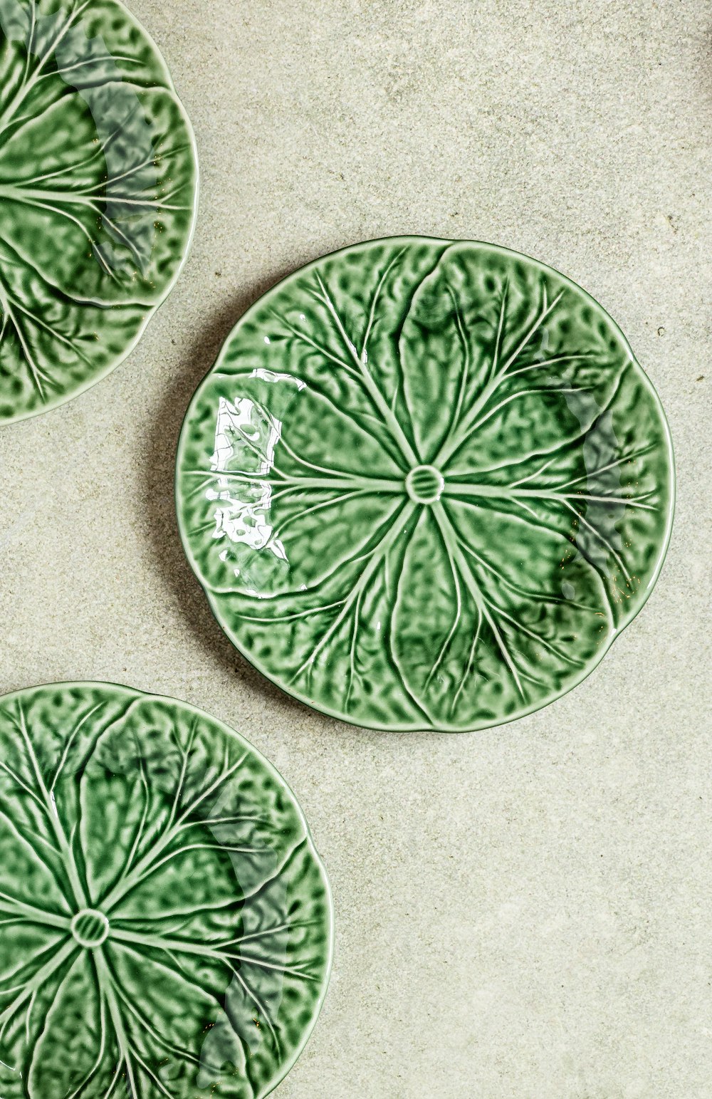 a couple of green plates sitting on top of a table
