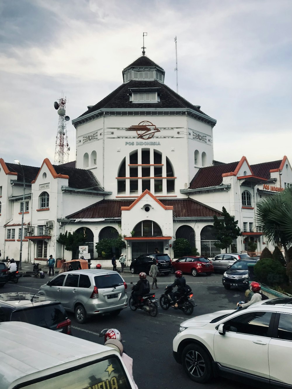 a large white building with cars parked in front of it