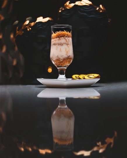 a glass filled with liquid sitting on top of a table