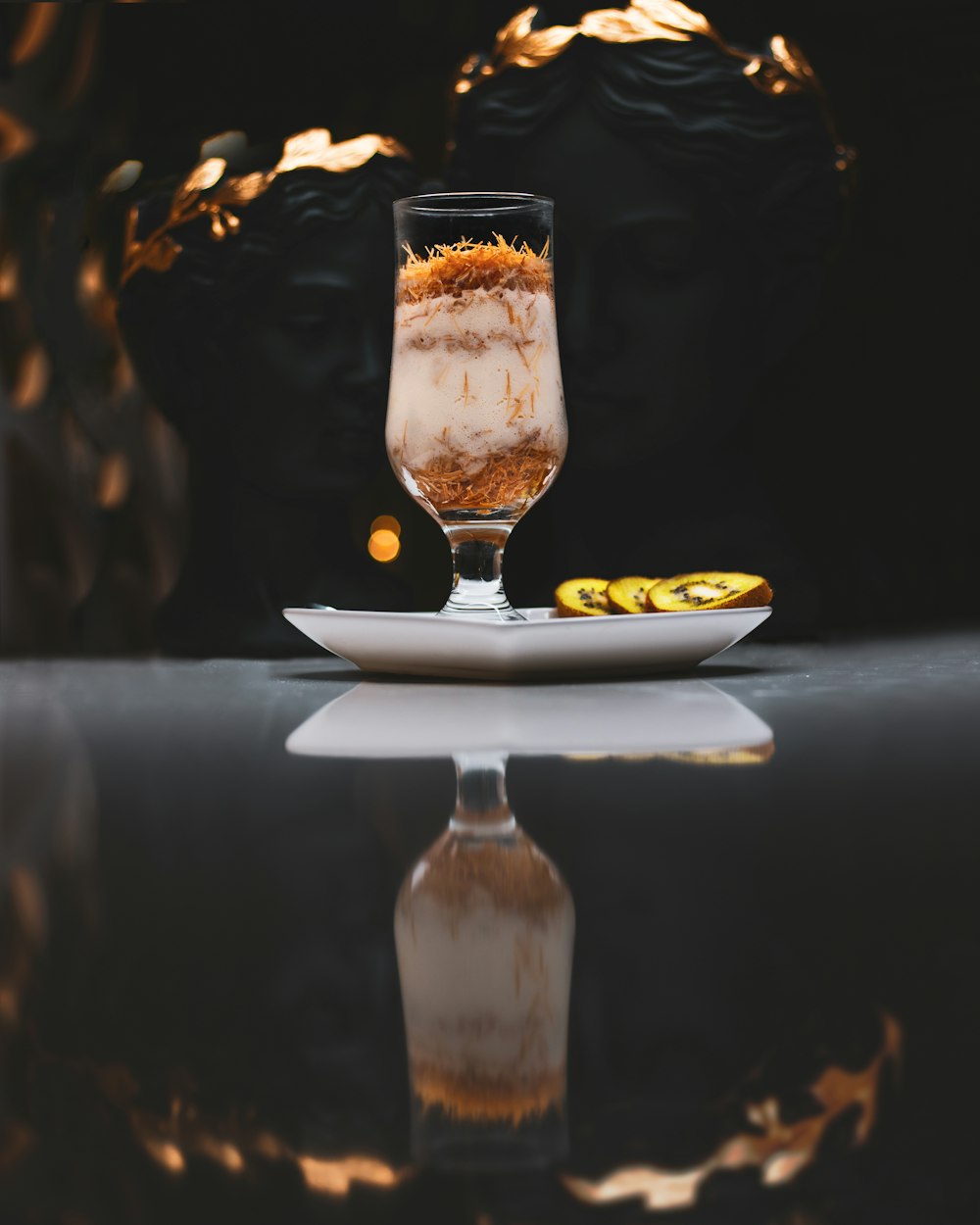 a glass filled with liquid sitting on top of a table