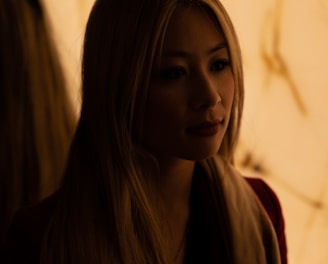 a woman with long blonde hair sitting down