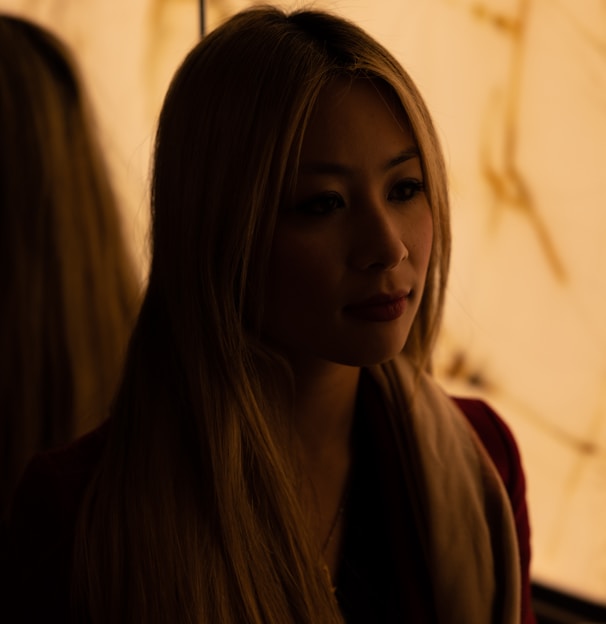 a woman with long blonde hair sitting down