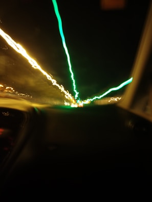 View through a spaceship window showing stars streaking by at warp speed.