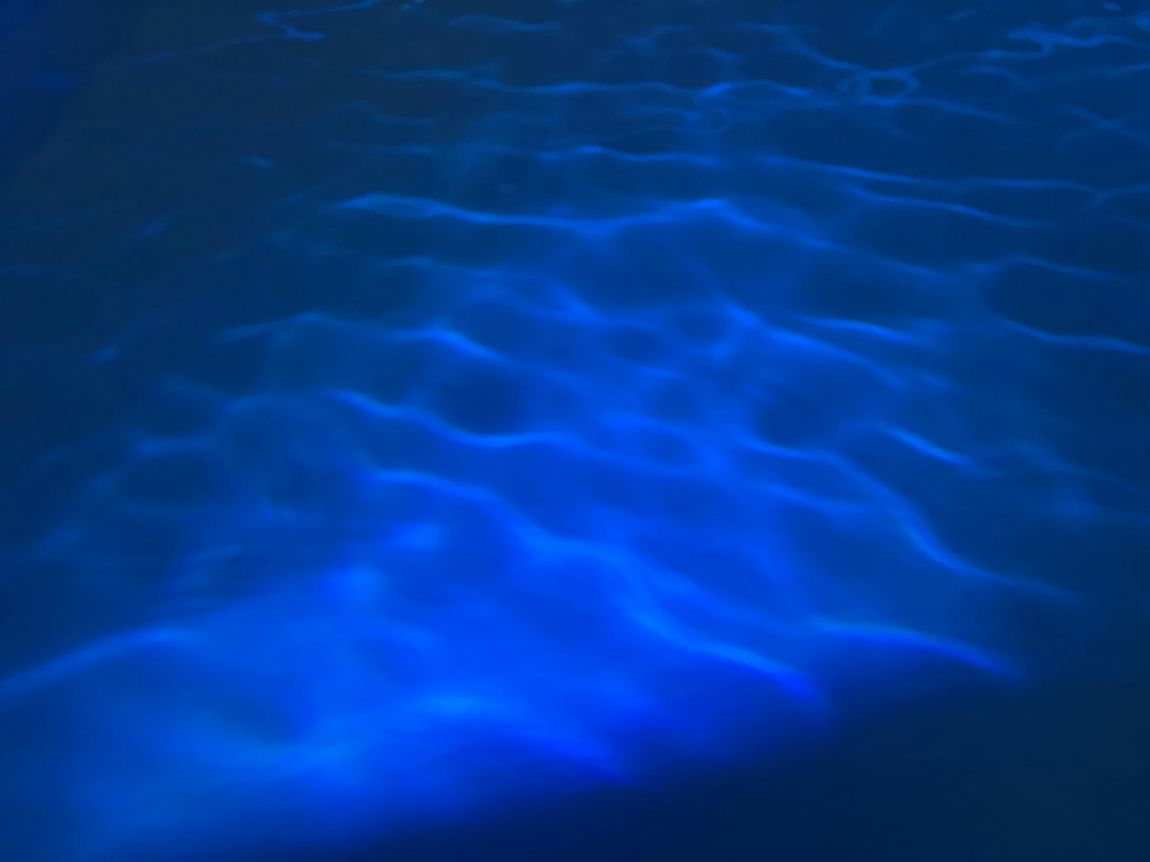 a pool with blue water is shown from above