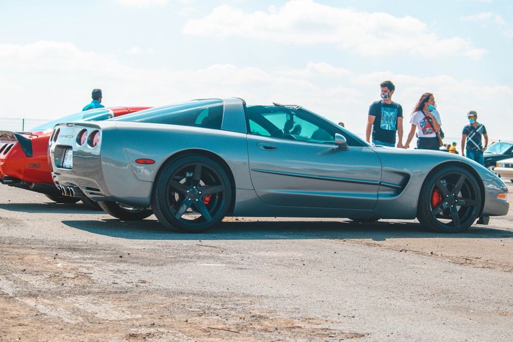 a silver sports car parked on the side of the road