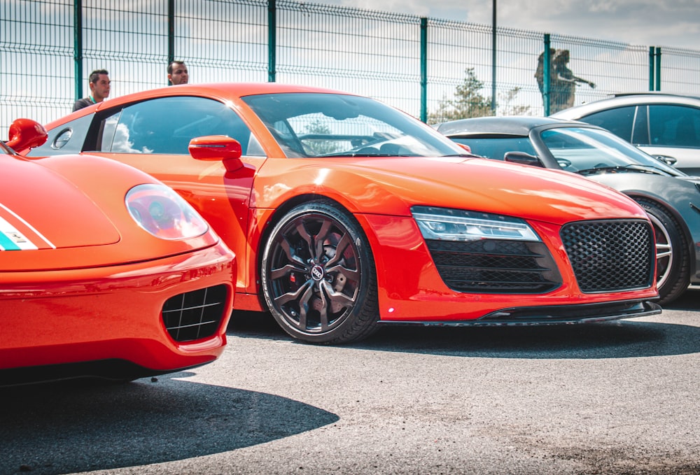 an orange sports car parked in a parking lot