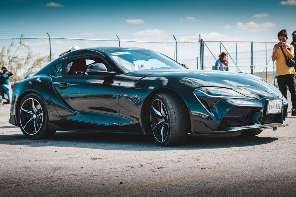 a blue sports car parked in a parking lot