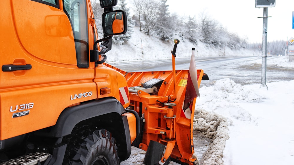 an orange truck parked on the side of the road