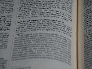 A close-up of a page from a book with text in two columns. The text includes a heading in bold, emphasizing the section titled 'Nehemiah inspects Jerusalem's walls'. The book appears to be a religious or historical text with a narrative style.