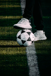 a person standing on top of a soccer ball