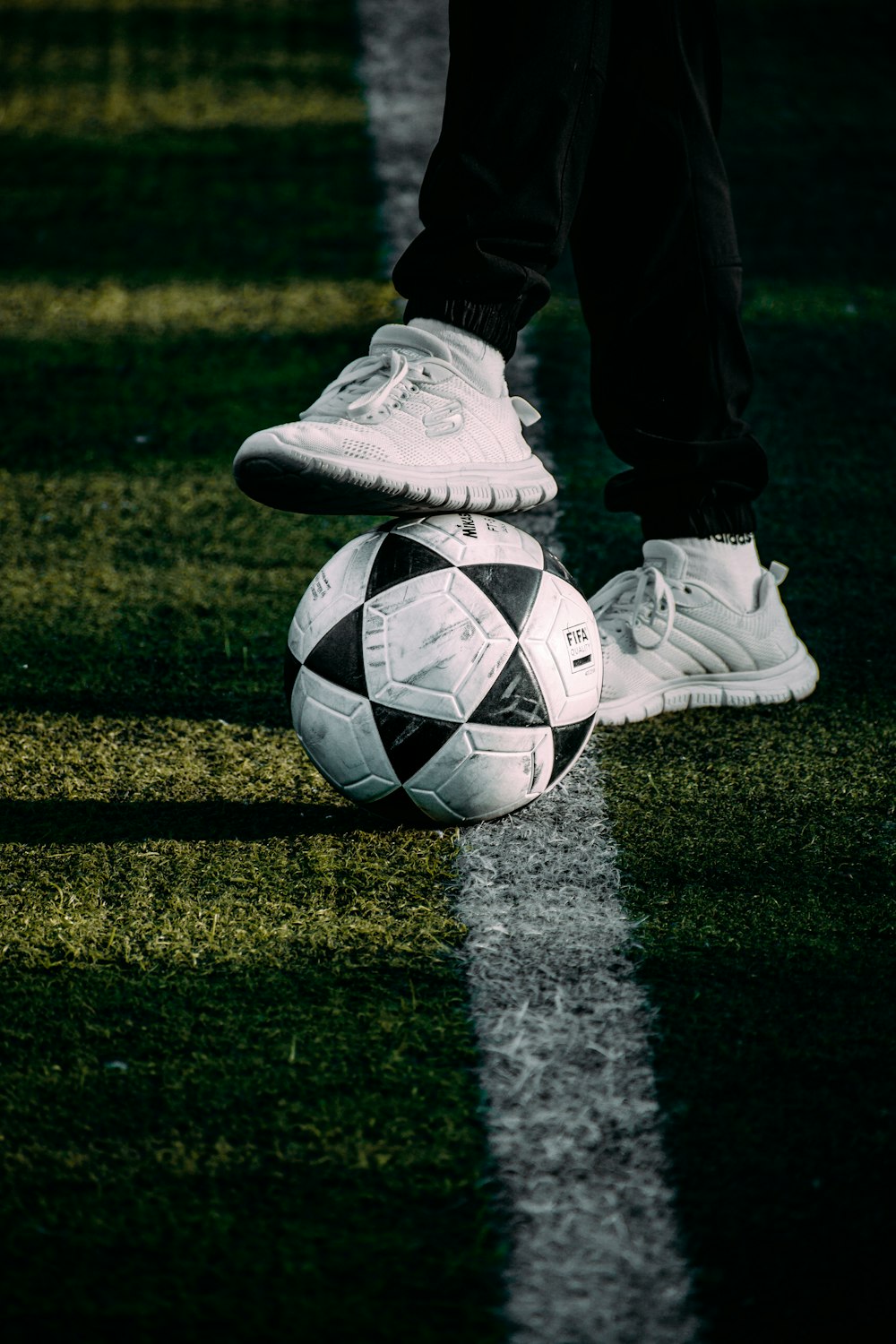 a person standing on top of a soccer ball