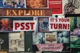 A collage of various signs and images with vintage and artistic styles. Includes text like 'EXPLORE', 'PSST', 'IT'S YOUR TURN!', and 'TODAY CHOCOLATE'. There are images of a coffee cup, a Caprice Motel sign, artistic drawings, and a photo with bears.