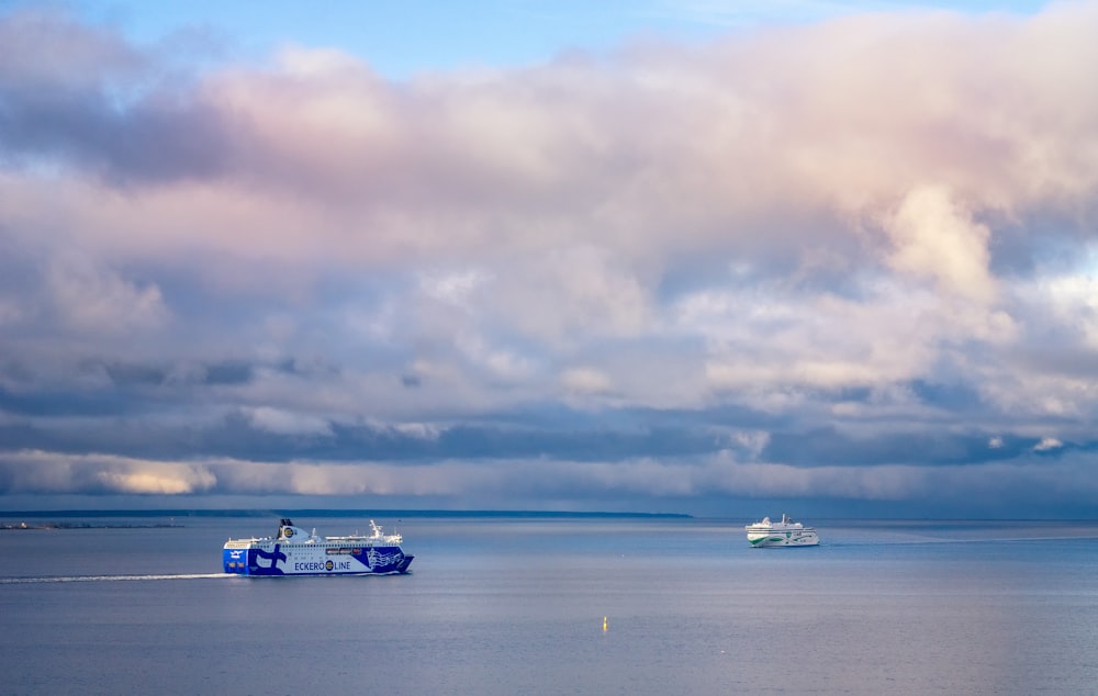 a couple of boats floating on top of a large body of water