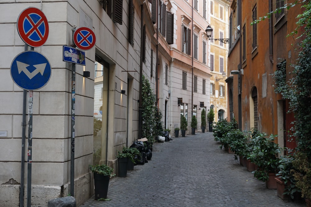 a narrow street with several signs on it
