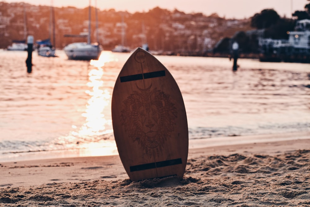 a surfboard sitting on top of a sandy beach