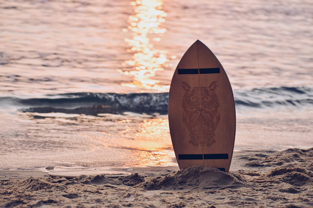 a surfboard sitting in the sand on the beach