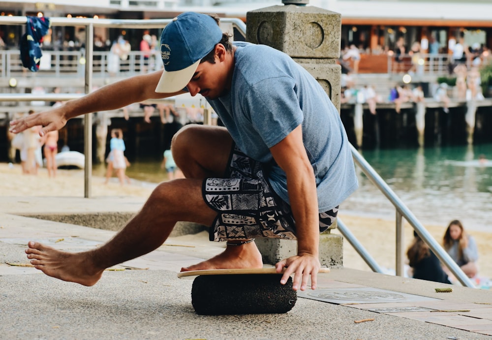 a man riding a skateboard down a sidewalk next to a body of water