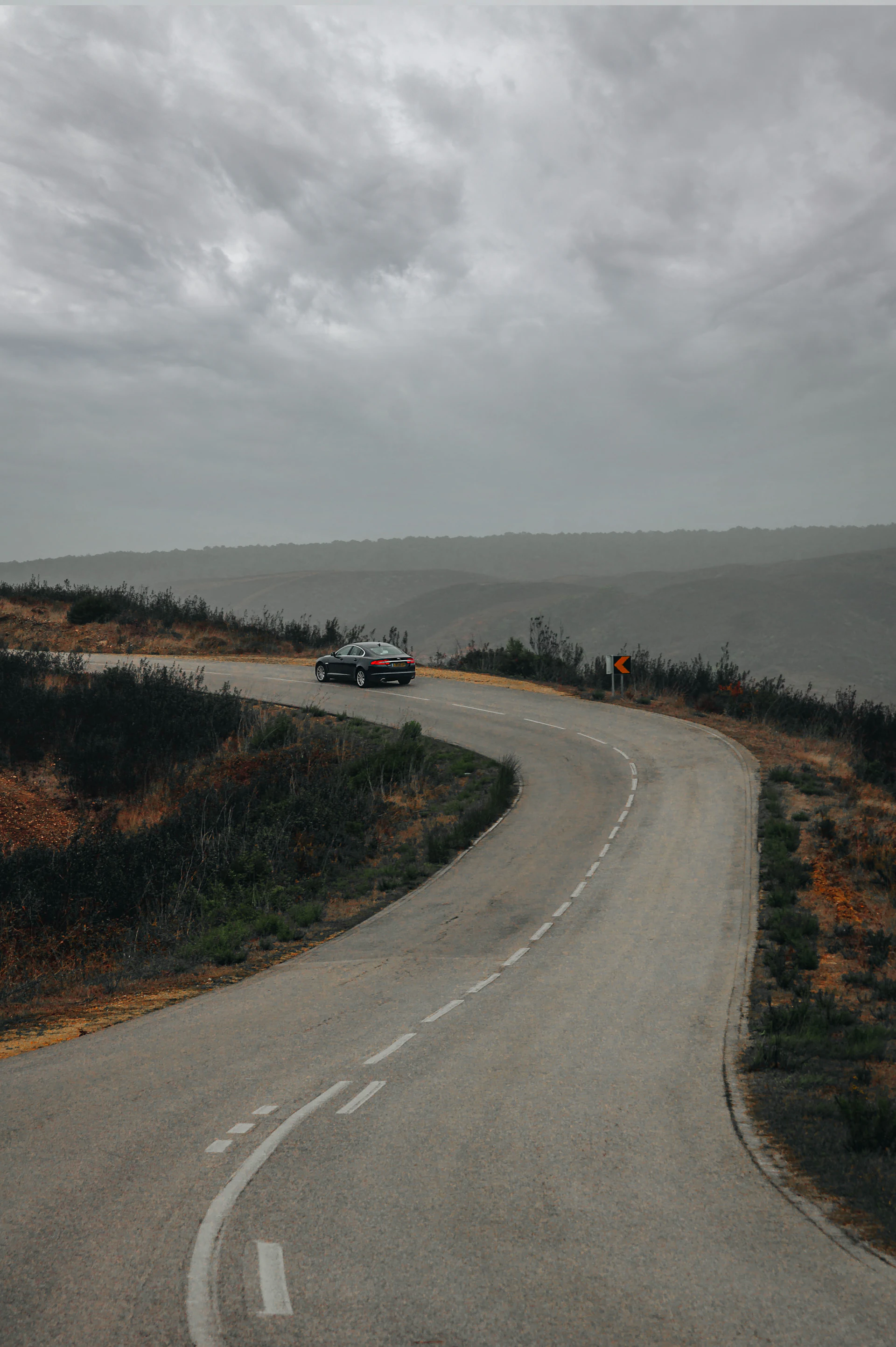 a car is driving down a winding road