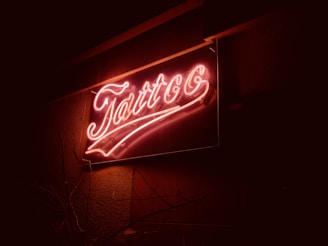 a neon sign that is on the side of a building