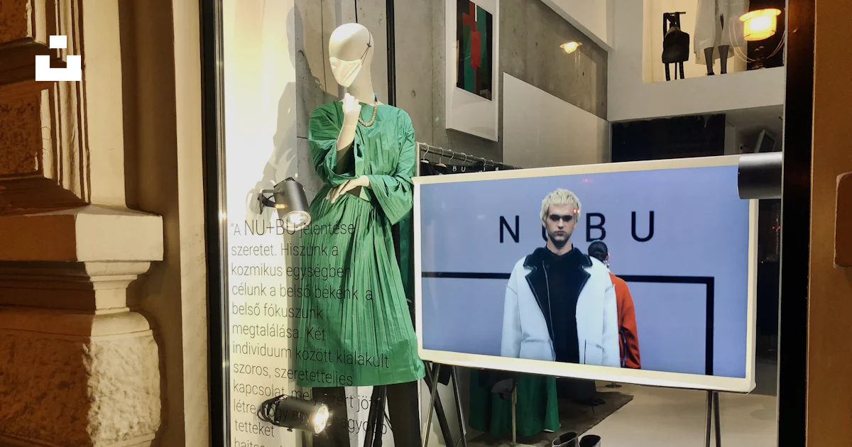 Window Display Human Figure A window display with mannequins dressed in green and black photo ...