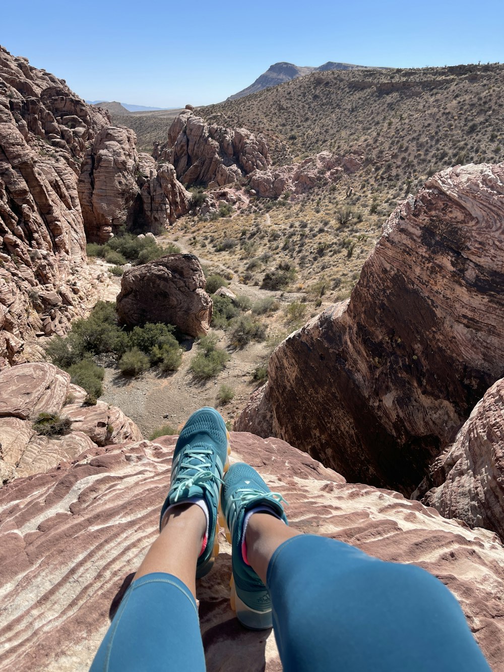 a person with their feet up on a rock