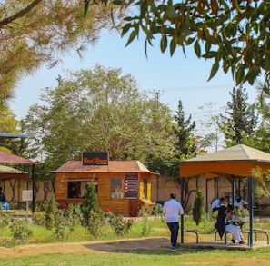 a group of people walking around a park