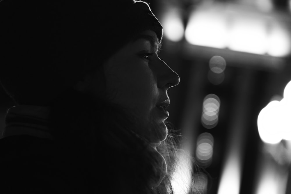 a black and white photo of a woman looking away