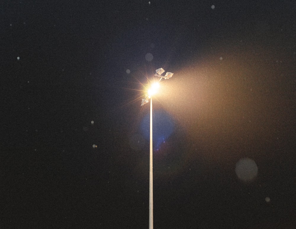 a street light on a pole in the dark