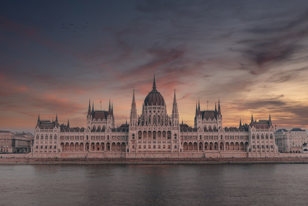 a large building sitting next to a body of water