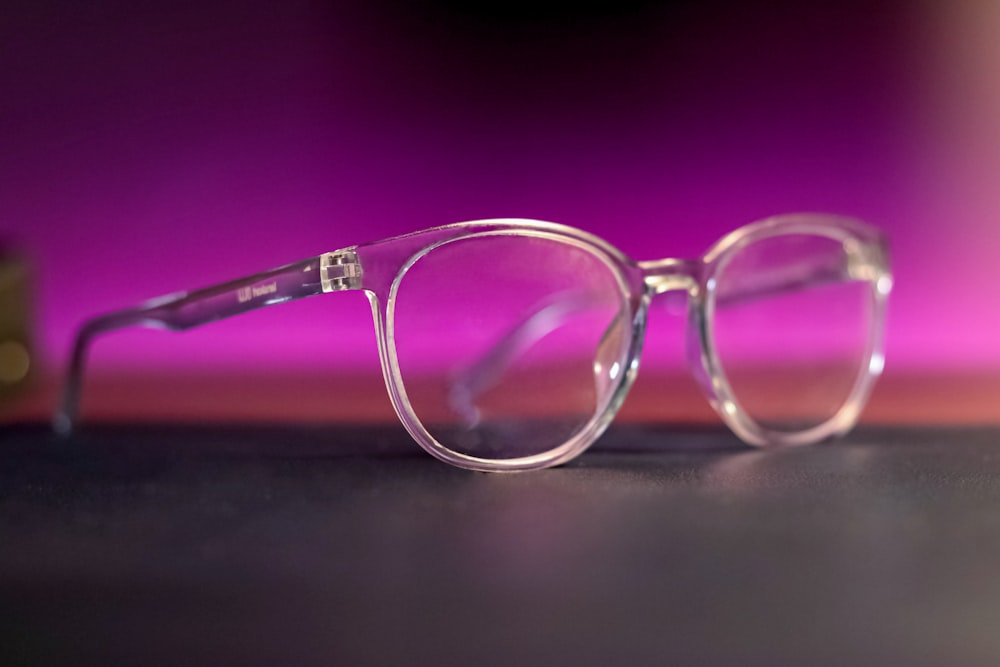 a pair of glasses sitting on top of a table